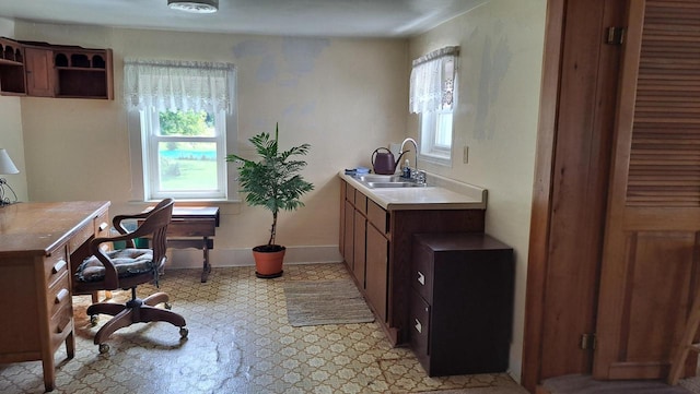 office area with baseboards and a sink