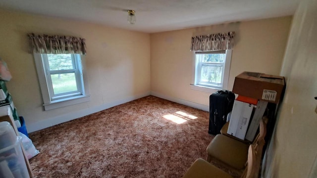 carpeted spare room featuring baseboards