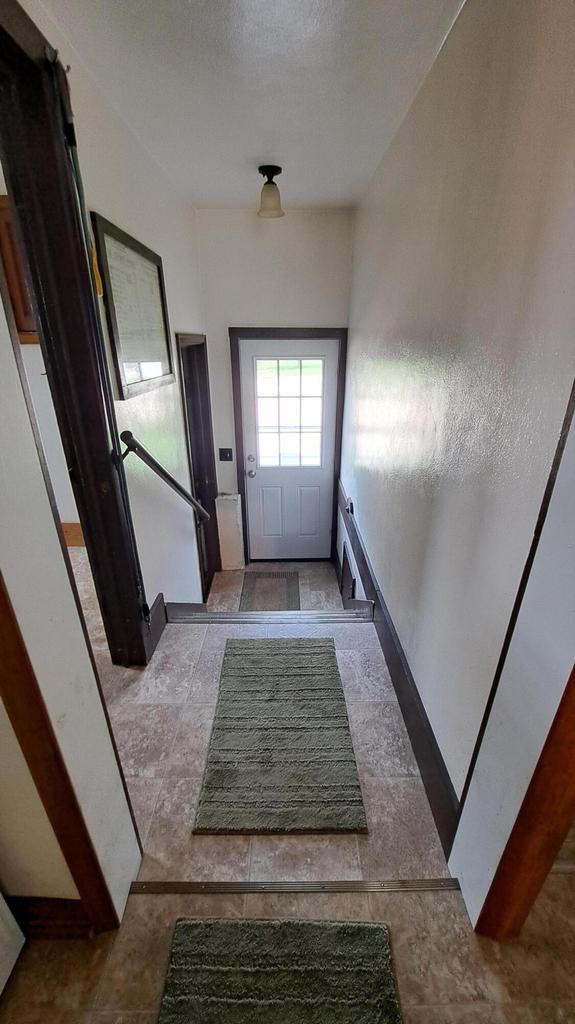 doorway to outside with a textured ceiling