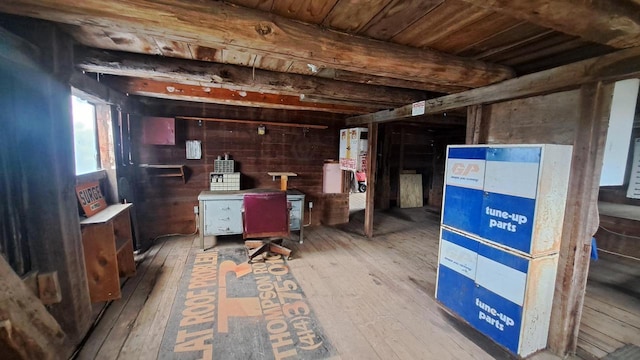 below grade area with hardwood / wood-style floors, wooden ceiling, and wood walls