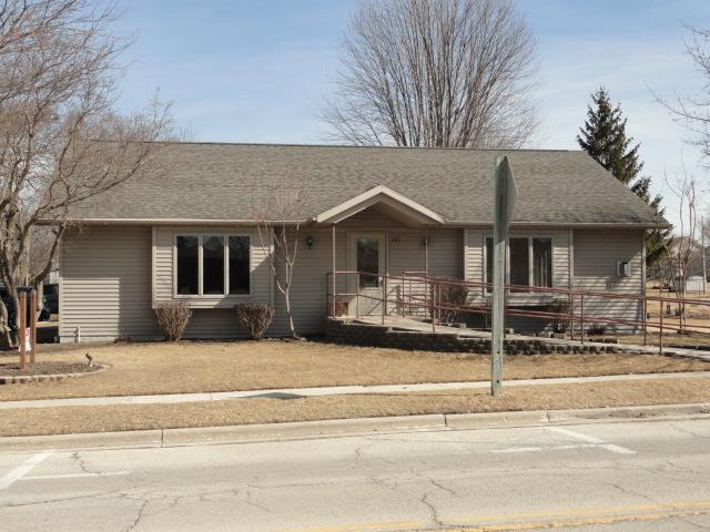 single story home with fence and roof with shingles