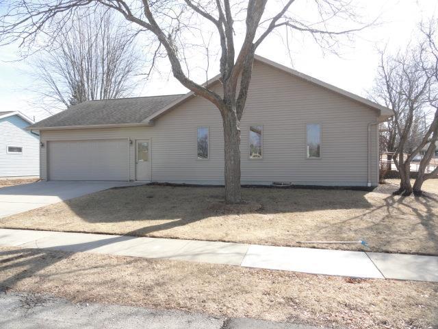 view of side of home with an attached garage and driveway