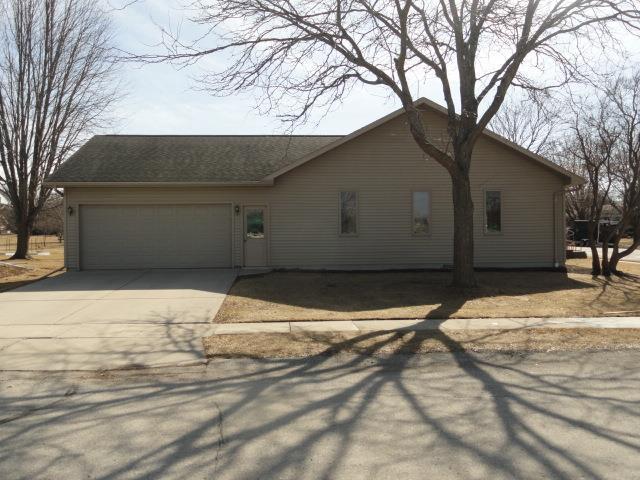 view of front of home featuring an attached garage, driveway, and roof with shingles