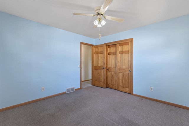 unfurnished bedroom featuring a closet, visible vents, baseboards, and carpet