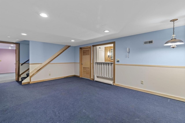 empty room featuring visible vents, dark carpet, recessed lighting, stairway, and baseboards