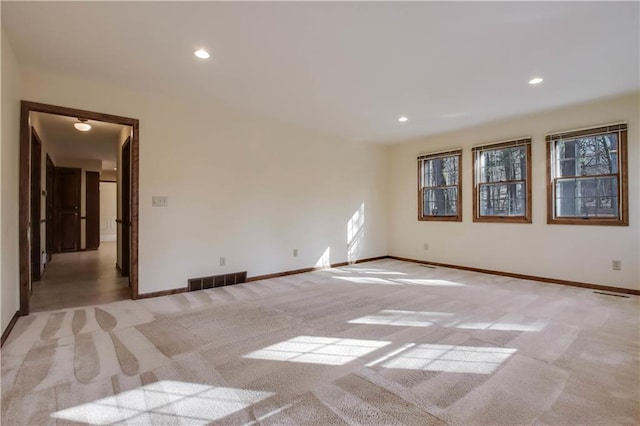 unfurnished room featuring recessed lighting, visible vents, baseboards, and light colored carpet