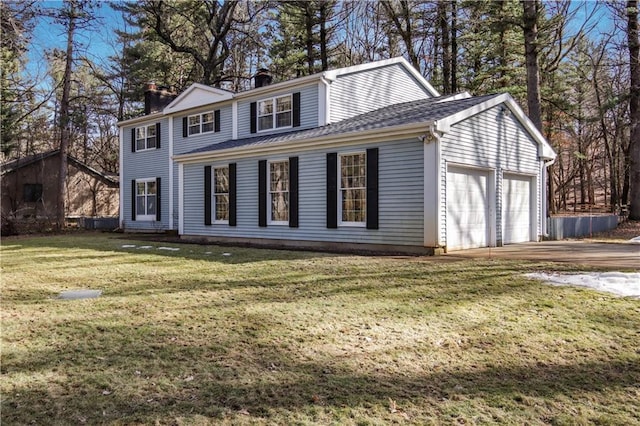 view of front of home featuring roof with shingles, concrete driveway, a front yard, an attached garage, and a chimney