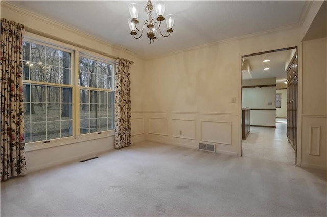 unfurnished room with a notable chandelier, a decorative wall, carpet, and ornamental molding