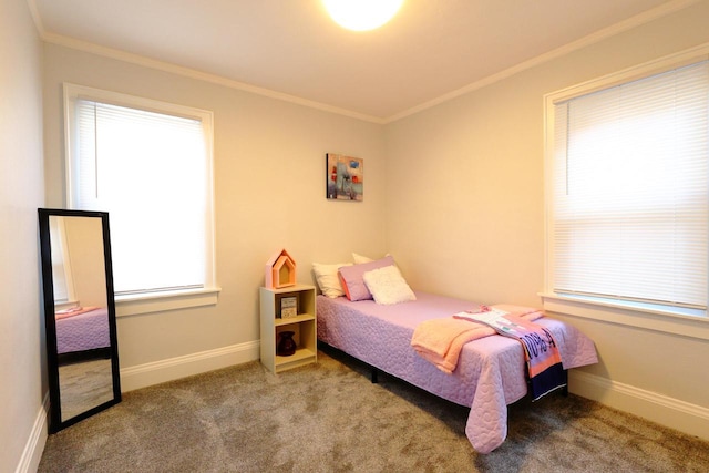 carpeted bedroom with crown molding and baseboards