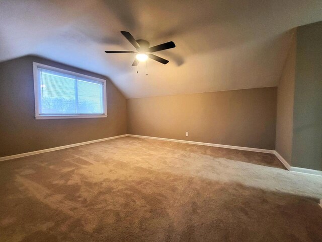 bonus room featuring vaulted ceiling, a ceiling fan, baseboards, and carpet floors