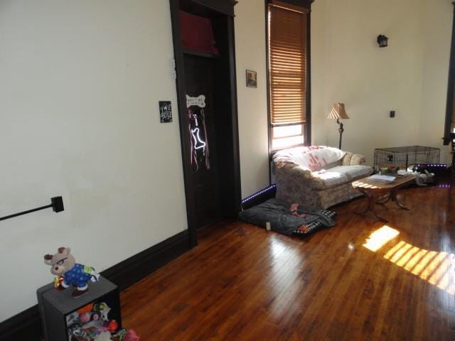 living room with baseboards and wood finished floors