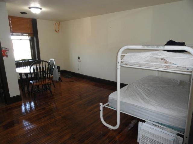 bedroom featuring baseboards and wood finished floors