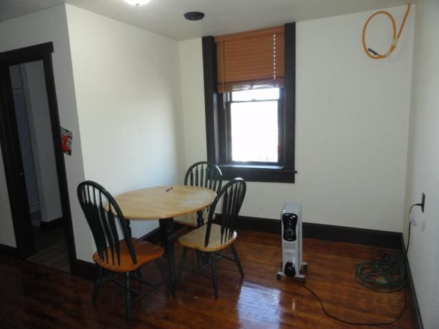 dining area featuring baseboards and wood finished floors