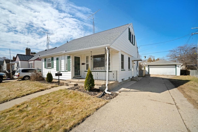 7514 32nd Ave, Kenosha, WI 53142 - bungalow-style home featuring a detached garage, an outbuilding, a front lawn, covered porch, and a shingled roof