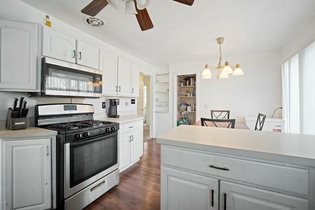 7514 32nd Ave, Kenosha, WI 53142 - kitchen featuring white cabinets, light countertops, appliances with stainless steel finishes, dark wood-type flooring, and ceiling fan with notable chandelier