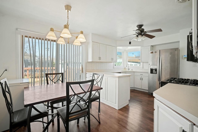 7514 32nd Ave, Kenosha, WI 53142 - dining space featuring dark wood-type flooring, a wealth of natural light, and ceiling fan with notable chandelier