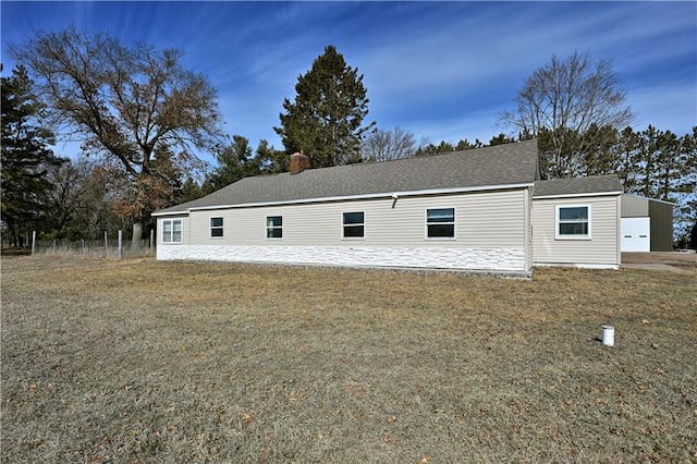 N7030 Little Valley Rd, Spooner, WI 54801 - exterior space with a yard, a garage, and a shingled roof