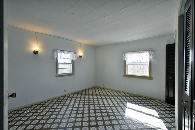 N7030 Little Valley Rd, Spooner, WI 54801 - spare room featuring tile patterned floors and baseboards