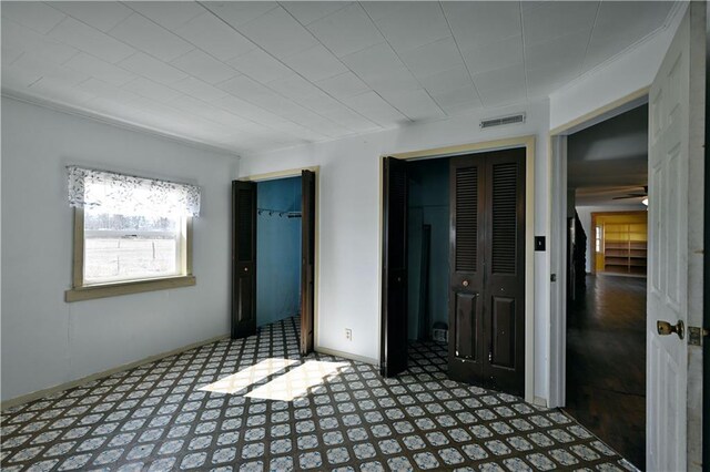 N7030 Little Valley Rd, Spooner, WI 54801 - unfurnished bedroom with tile patterned floors, visible vents, and baseboards