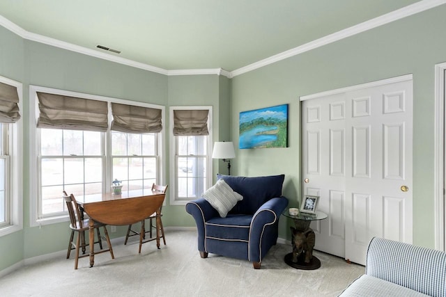 living area featuring visible vents, carpet, a healthy amount of sunlight, and ornamental molding