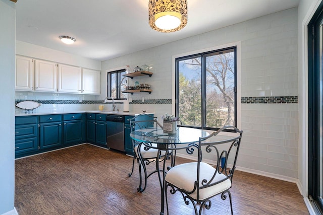 dining room featuring baseboards, a healthy amount of sunlight, and dark wood finished floors