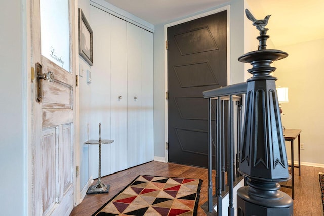 entrance foyer featuring baseboards and wood finished floors