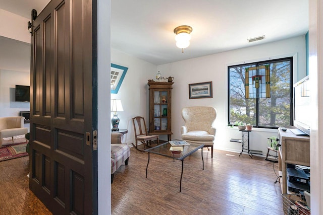 living room with visible vents and dark wood-style flooring