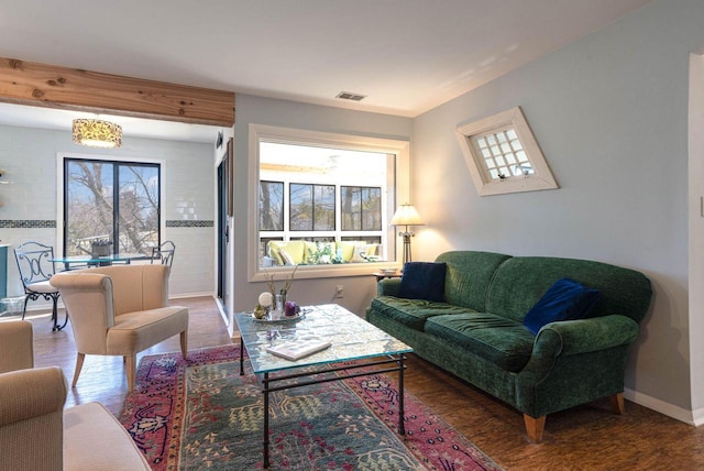 living room featuring baseboards and visible vents