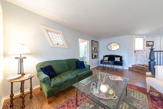 living room with baseboards and wood finished floors