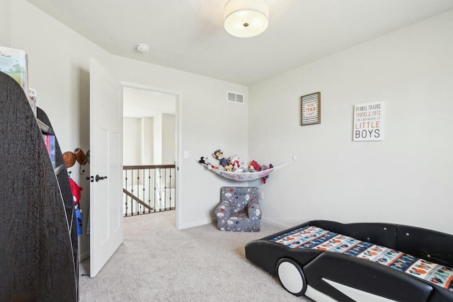 carpeted bedroom featuring visible vents and baseboards