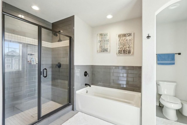 bathroom featuring toilet, a bath, a shower stall, and tile patterned flooring