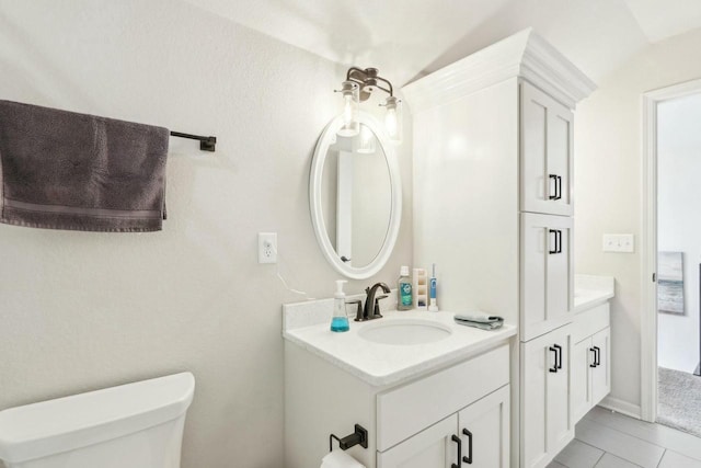 bathroom featuring tile patterned floors, toilet, and vanity