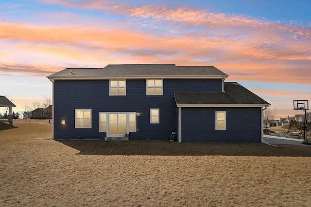 view of back of house at dusk