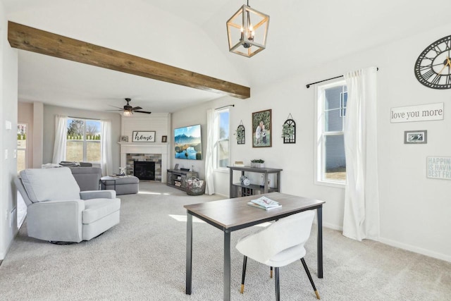 carpeted living area featuring baseboards, vaulted ceiling with beams, ceiling fan, and a fireplace