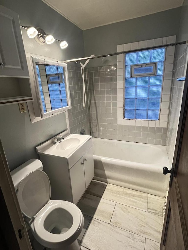 bathroom with vanity, toilet, and shower / bath combination