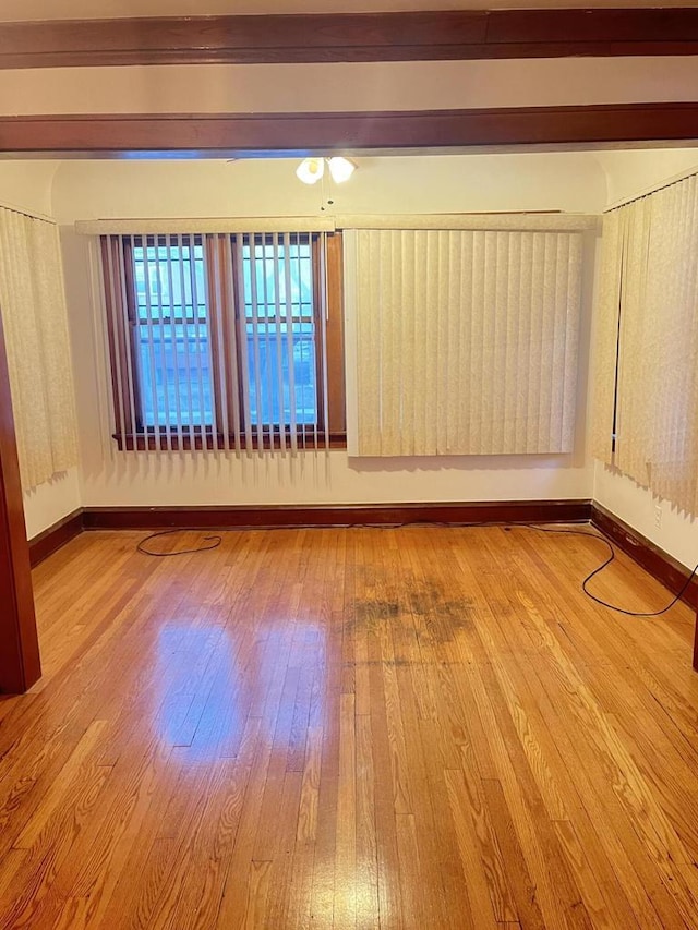 empty room with hardwood / wood-style flooring and baseboards