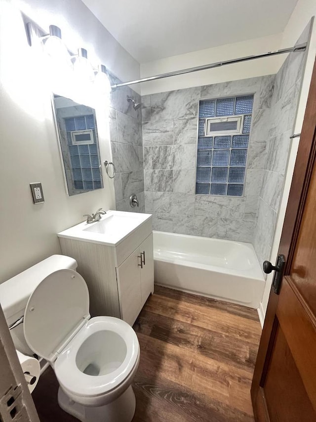 full bathroom featuring vanity, toilet, wood finished floors, and shower / bathtub combination