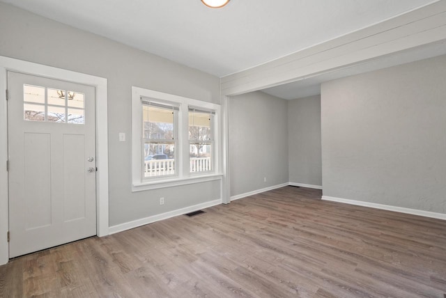 entrance foyer with visible vents, baseboards, and wood finished floors