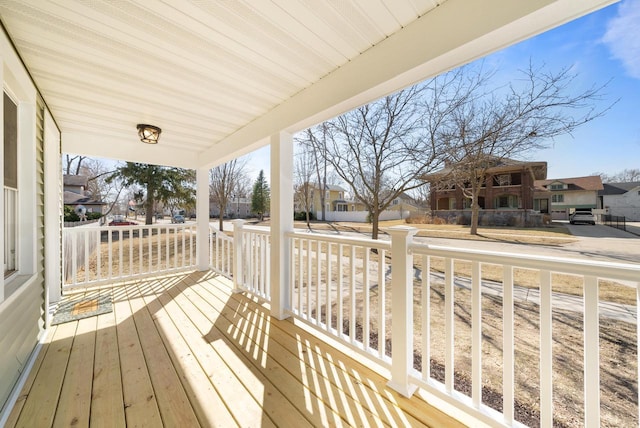 deck with a porch and a residential view