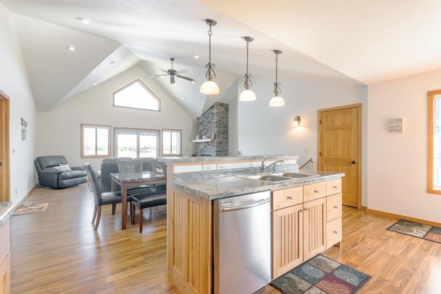 kitchen featuring a ceiling fan, a center island with sink, light wood-style flooring, dishwasher, and open floor plan