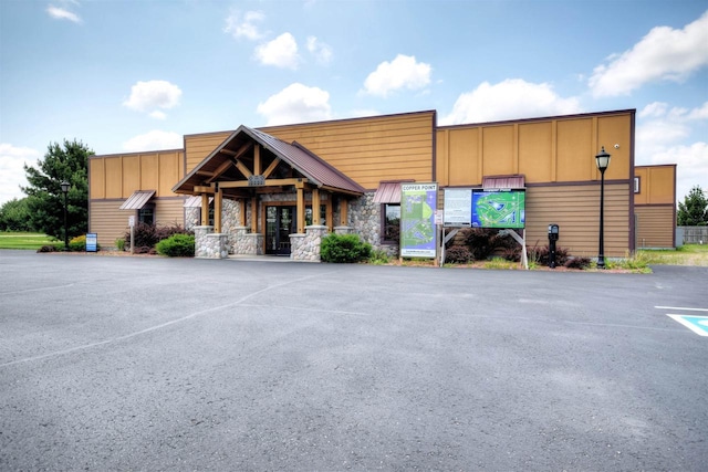 view of building exterior featuring uncovered parking