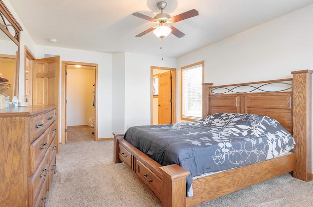 bedroom featuring light carpet, baseboards, and a ceiling fan