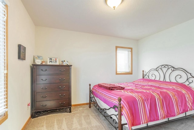 carpeted bedroom with baseboards