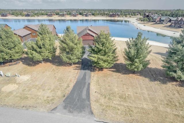 birds eye view of property with a water view and a residential view