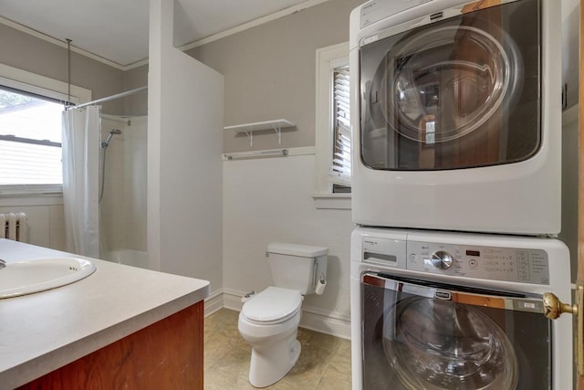 bathroom with toilet, stacked washer and clothes dryer, a shower with shower curtain, radiator, and crown molding