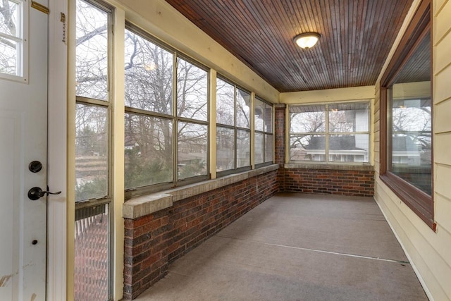 unfurnished sunroom with wood ceiling