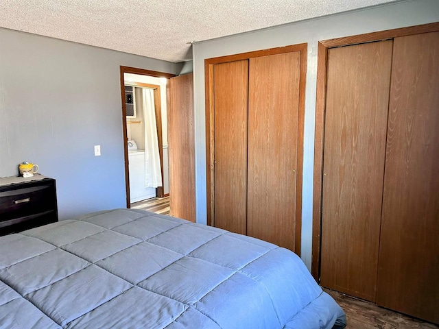 bedroom featuring multiple closets and a textured ceiling