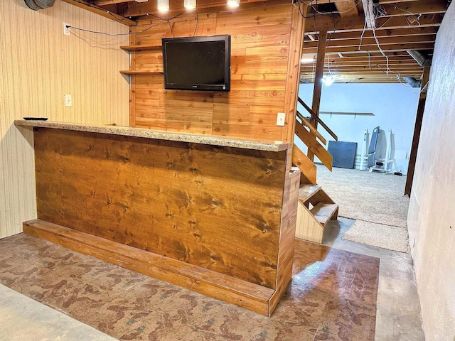 bar featuring stairway and concrete flooring