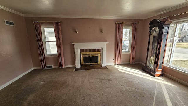 unfurnished living room featuring visible vents, a fireplace, crown molding, and baseboards