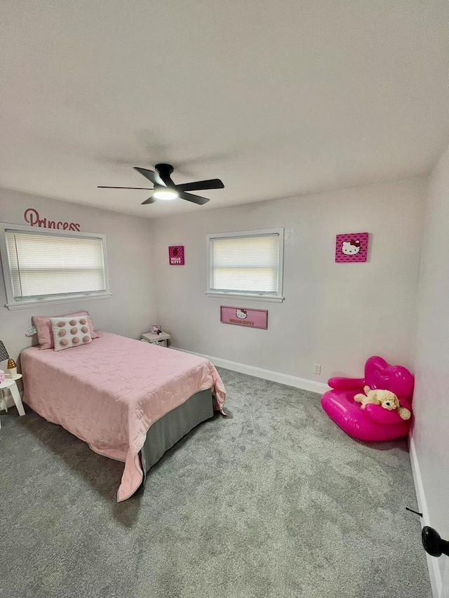 carpeted bedroom featuring baseboards and ceiling fan